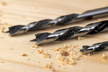 metal drill bit and pine wood board during operation