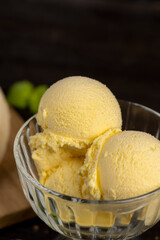 creamy ice cream with yellow banana slices in a glass cup