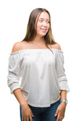 Fototapeta premium Young caucasian beautiful woman over isolated background looking away to side with smile on face, natural expression. Laughing confident.