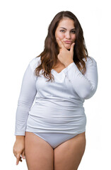 Beautiful plus size young overwight woman wearing white underwear over isolated background looking confident at the camera with smile with crossed arms and hand raised on chin. Thinking positive.