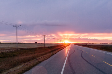 A road with a sunset in the background