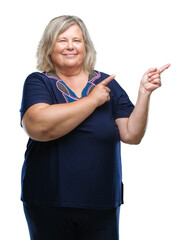 Obraz premium Senior plus size caucasian woman over isolated background smiling and looking at the camera pointing with two hands and fingers to the side.