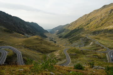 An amazing drone view of the Transfăgărășan in the evening captures the winding road as it snakes through the majestic Făgăraș Mountains in Romania. 