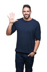 Fototapeta premium Young handsome man wearing sweater over isolated background showing and pointing up with fingers number five while smiling confident and happy.