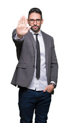 Young handsome business man over isolated background doing stop sing with palm of the hand. Warning...