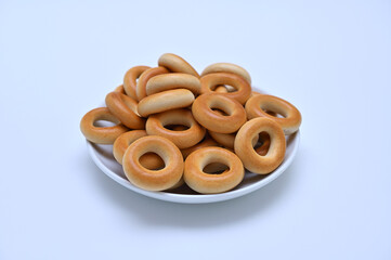 plate with small bagels on a white background close-up 