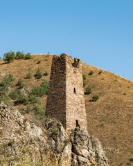 old stone Military Towers of Vovnushki in Ingushetia, Russia blue background sky