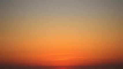 Fototapeta premium Vintage sunset gradient with burnt orange and golden yellow blending into a soft blue sky