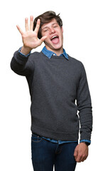 Naklejka premium Young handsome elegant man over isolated background showing and pointing up with fingers number five while smiling confident and happy.