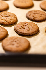 Oven tray with fresh hot gingerbread cookies, traditional Christmas recipe. aroma and taste of new year holidays