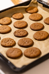 Oven tray with fresh hot gingerbread cookies, traditional Christmas recipe. aroma and taste of new year holidays