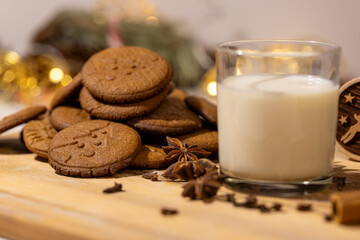 homemade gingerbread cookies with a glass of milk and spices: anise, cloves and cinnamon....