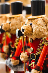 Close-up of a Christmas teddy bear soldier arranged in a row, on a blurred background, vertical photo