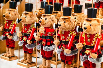 Christmas soldier teddy bears lined up in a row, on a blurred background