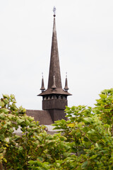 A charming wooden church located at a zoo in Constanța, Romania, surrounded by lush greenery and a tranquil atmosphere