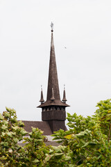 A charming wooden church located at a zoo in Constanța, Romania, surrounded by lush greenery and a tranquil atmosphere