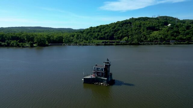 Historic New York lighthouse with mountains in the background, drone 4K