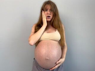 Sad worried pregnant woman feeling bad, depressed on white background