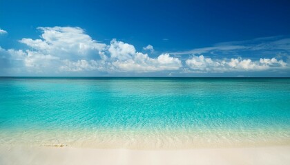 Fototapeta premium beach and beautiful tropical sea warm summer sea with blue water white clouds on a blue sky over summer sea tropical sea relax