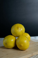 A collection of lemons spread out on a table, emphasizing abundance and freshness.
