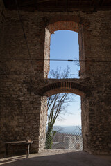 Obraz premium old stone arch, historical tower view throught the windows.