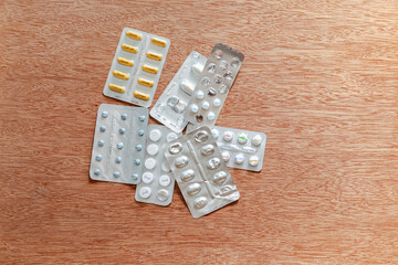 Pharmaceutical blister packs drugs, with essential steps for a healthy body. Workout exercises: squats, running, push-ups, crunch, plank, lunges, jumping, run, proteins, sleep and healthy eating care.
