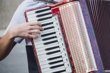Accordionist's hands masterfully play the accordion on the street