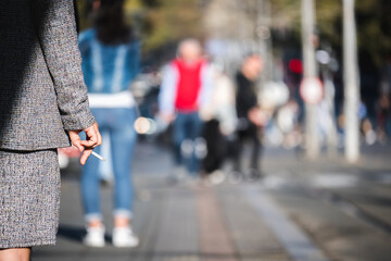 People smoke cigarettes while waiting for public transport
