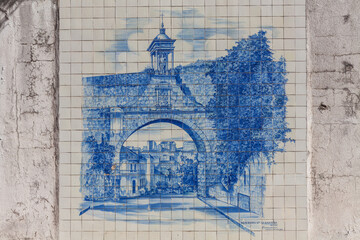 A stunning azulejo tile mural depicting the Porta de Almedina, a historic gate in Coimbra, Portugal © wundermann