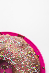 Traditional Gugelhupf cake with chocolate topping and colorful sprinkles