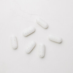 White supplement pills close up. Dietary supplement. Alternative medicine.