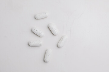 White supplement pills close up. Dietary supplement. Alternative medicine.