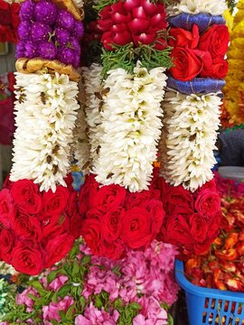 Indian flowers necklaces in Singapore market, whit bees and wasps in Jasmine flowers