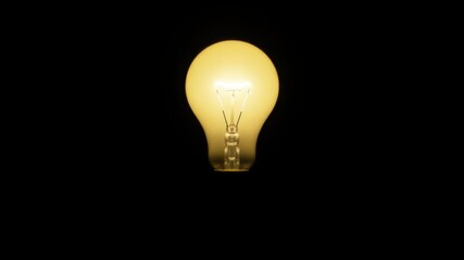 A single glowing light bulb standing out against a dark black background, energy, minimalism, science