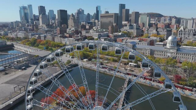 Soar above Montreal's iconic landmarks with this stunning aerial drone footage. The clip captures a mesmerizing flight passing over a gigantic Ferris wheel, gliding gracefully into the city skyline.