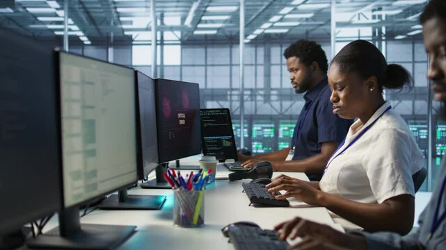 IT staff members seeing critical error popup on PC screen in data center, requesting help from cybersecurity team. Server hub coworkers struggling to eliminate cyberattacks affecting network, camera A