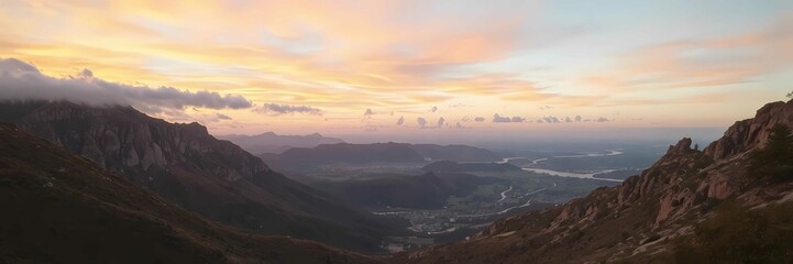 Fototapeta premium A tranquil mountain landscape at sunset with vibrant colors and soft clouds