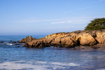 View of bluffs overlooking the Pacific Ocean in daytime, blue sky, soft clouds, nobody	