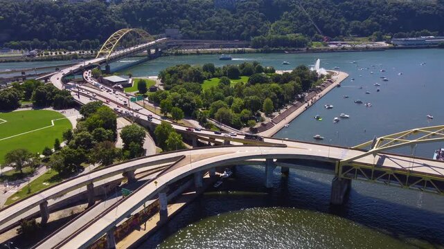 Soar above the scenic Fort Duquesne Park in Pittsburgh, PA, with this captivating aerial drone footage. This clip provides a stunning view of the park's lush greenery and vibrant activity.