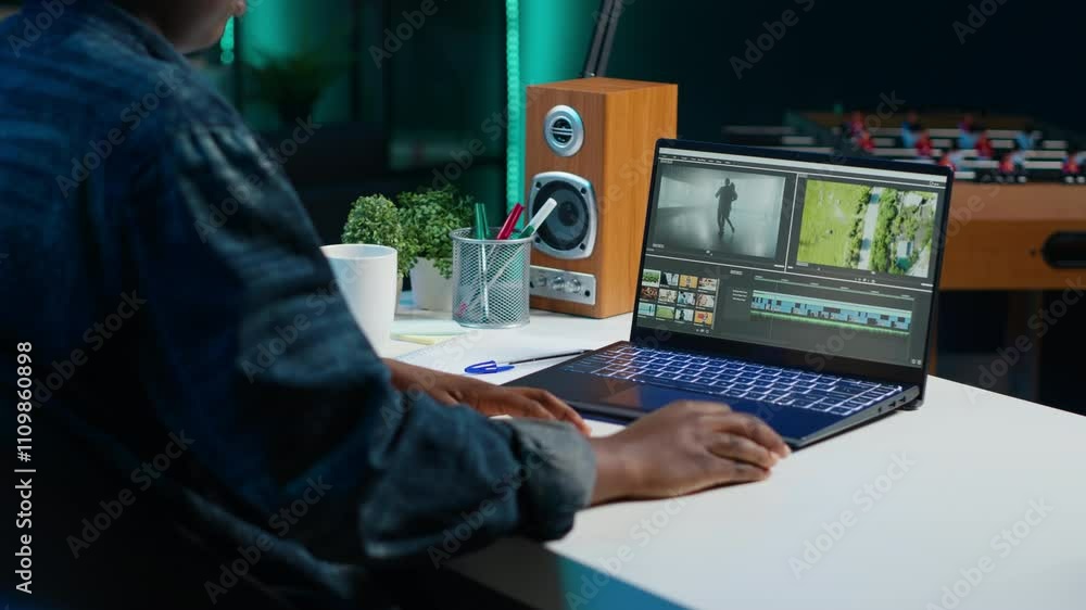 Poster video editor selecting key frames to use while doing video montage, working from home on notebook de