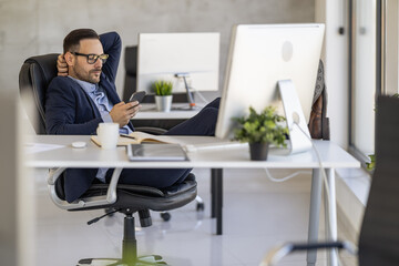 Relaxed Businessman Using Smartphone in Modern Office Setting