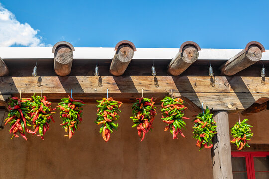 Dried Red and Green Hatch Chiles Hanging from Support Beams on an Adobe Mud Brick Building, Albuquerque, New Mexico, United States
