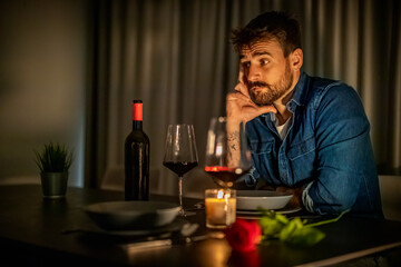 Pensive Man Reflecting During Candlelit Dinner at Home