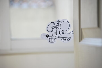 Cartoon mouse looking behind a door