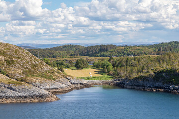 A Farm on a Fjord Nestled Among Green Forested Hills, in Northern Norway, near Trøndelag