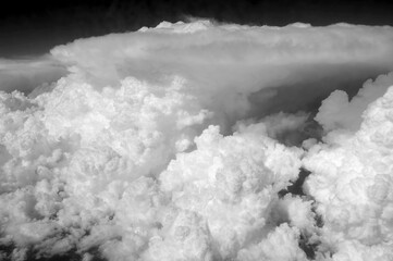 The sky is filled with white clouds, and the clouds are very low to the ground