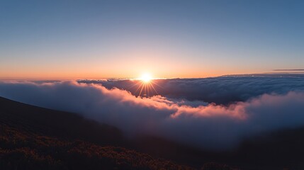 Panoramic sunset view above cloudscape, vibrant colors paint the sky and clouds.