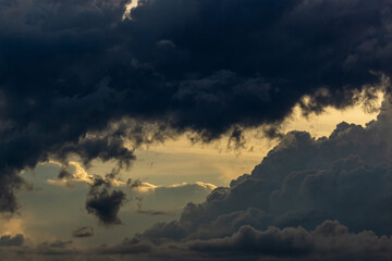 Dramatic sky with dark clouds at sunset, natural background.