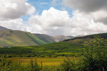 A beautiful mountain range with a cloudy sky in the background