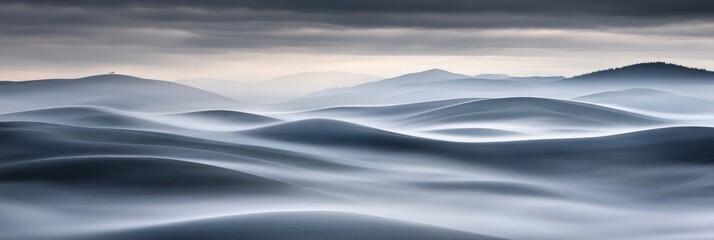 Serene undulating hills shrouded in mist, evoking tranquility and natural beauty.